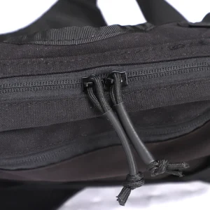 Close-up of black chest bag zipper pulls and durable fabric construction