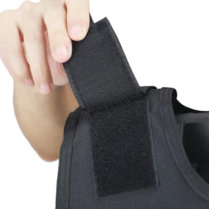 Close-up of adjustable shoulder hook-and-loop strap on black tactical vest