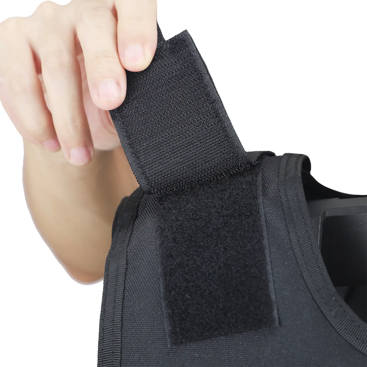 Close-up of adjustable shoulder hook-and-loop strap on black tactical vest