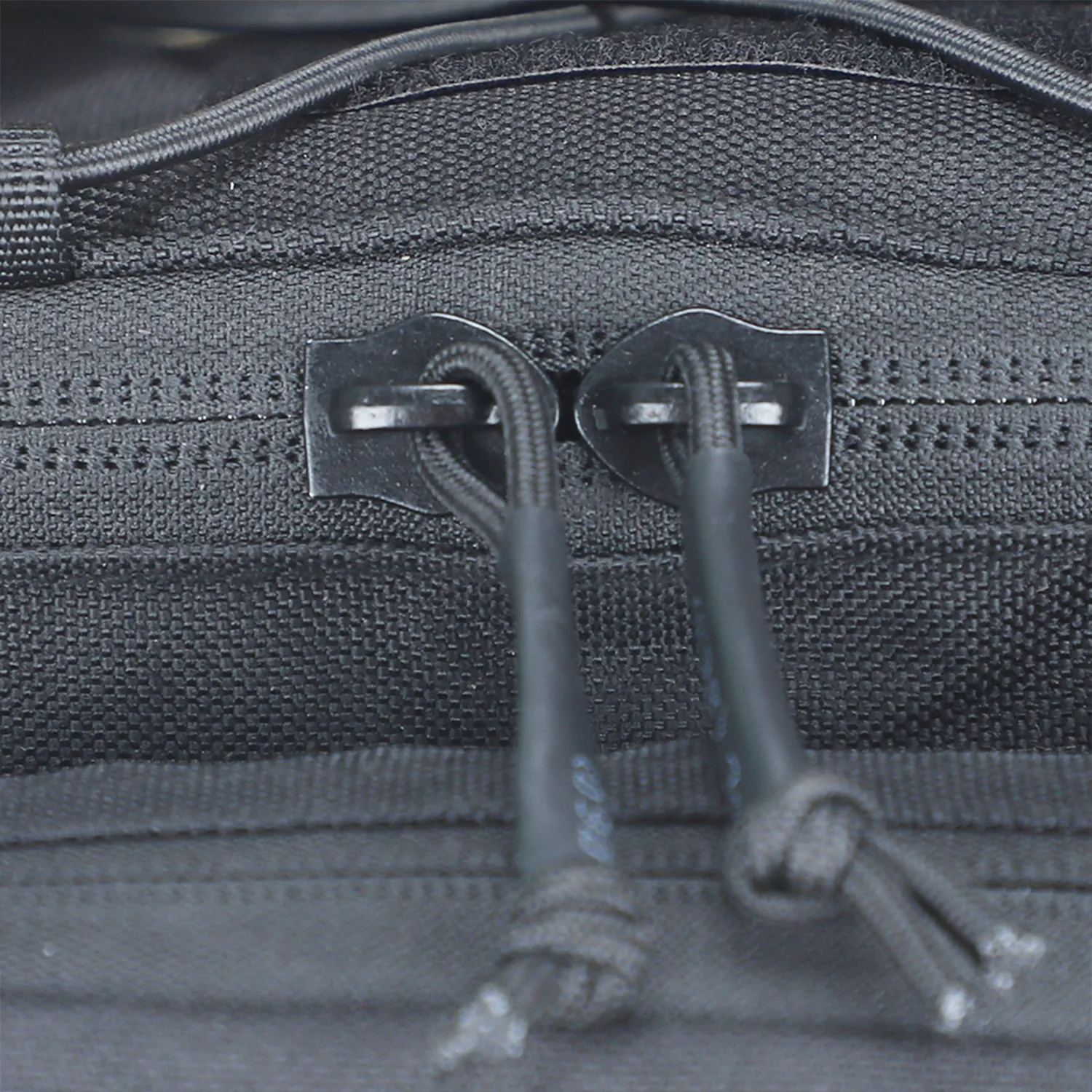 Close-up of zipper pulls on black tactical waist bag