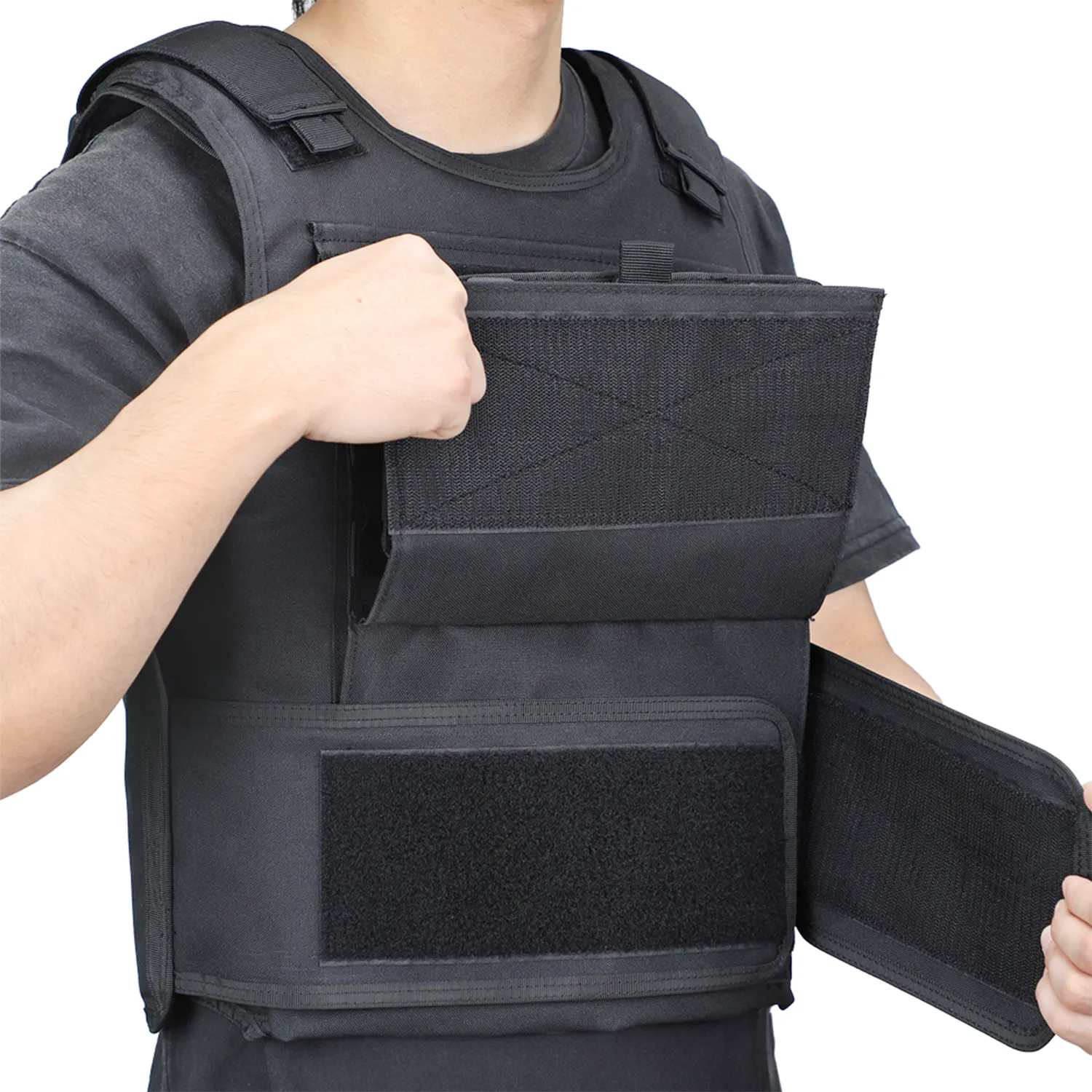 Black tactical vest worn with front flap opened for fit adjustment