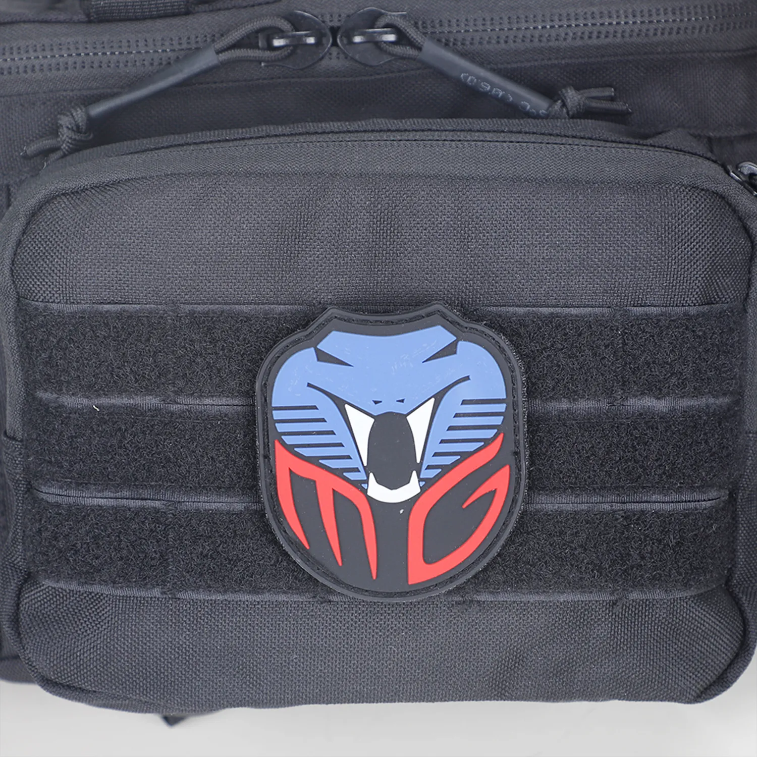 Front pocket of tactical waist bag with loop panel and removable patch