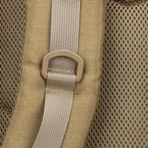 Close-up of shoulder strap D-ring and breathable mesh padding on tan tactical backpack