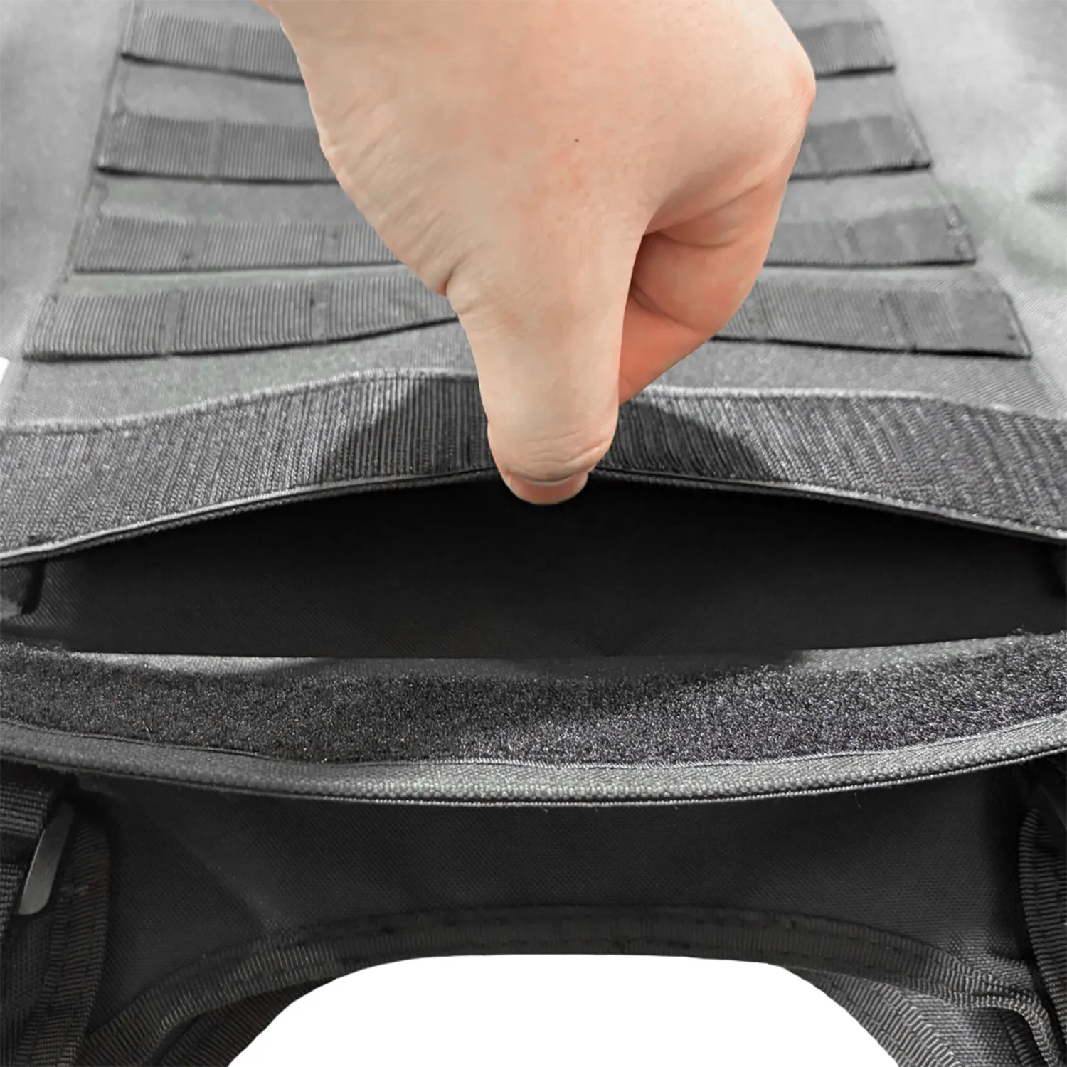 Close-up of rear compartment opening on black tactical vest