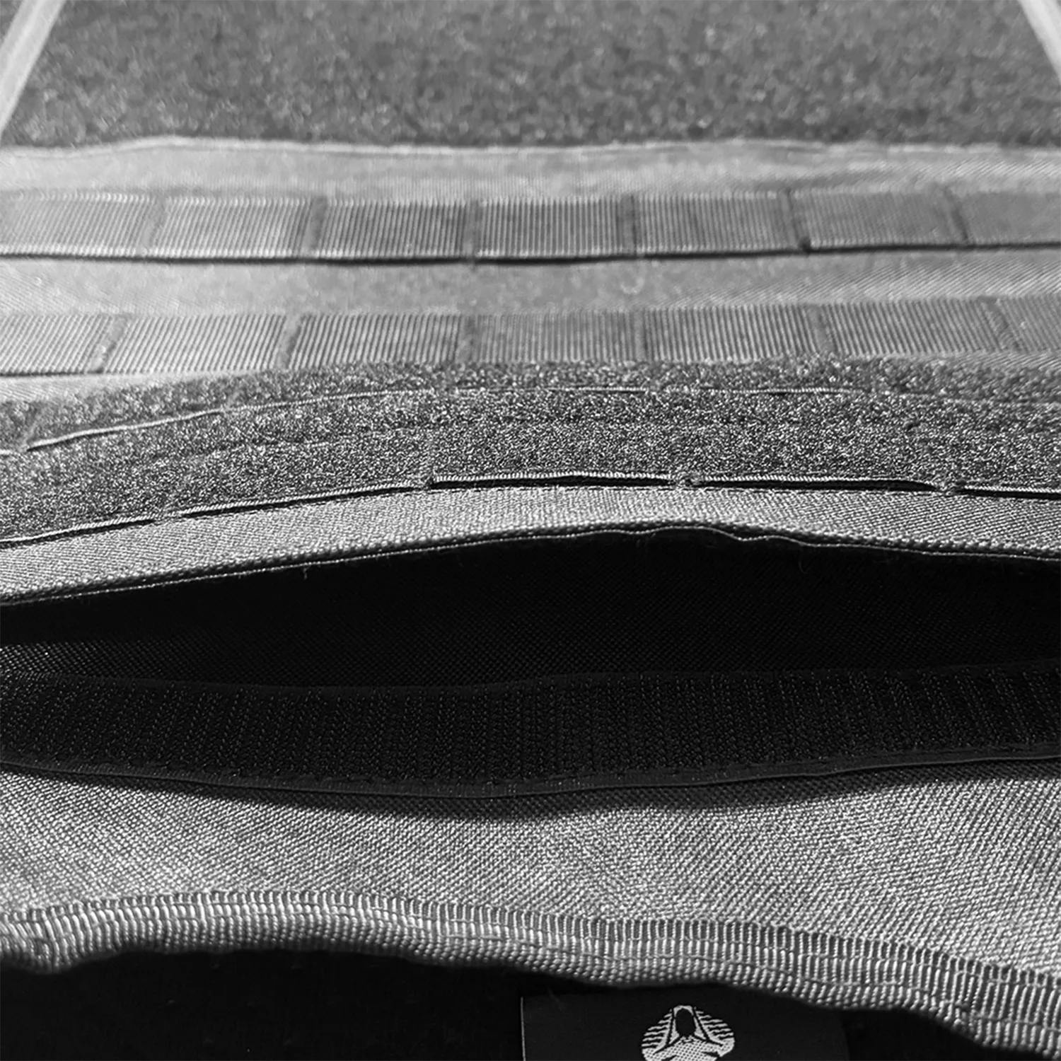 Close-up of internal pocket opening on black tactical vest