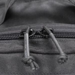 Close-up of durable zipper pullers on black tactical backpack fabric